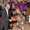 President Granger presenting the Medal of Service to Ms. Rogers in 2016