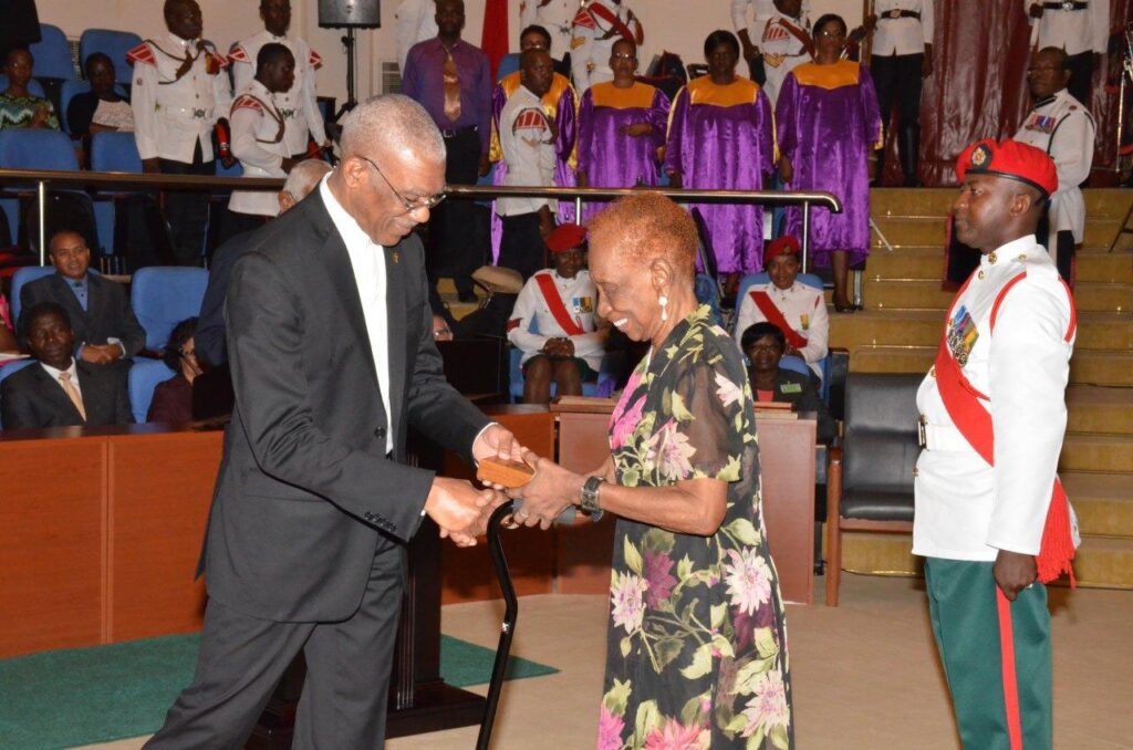 President Granger presenting the Medal of Service to Ms. Rogers in 2016