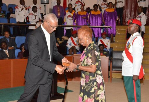 President Granger presenting the Medal of Service to Ms. Rogers in 2016